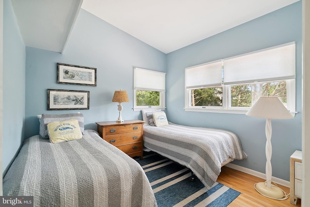 365 Dusty Miller Dr, Long Beach, NJ 08008 - bedroom with multiple windows, wood finished floors, and lofted ceiling