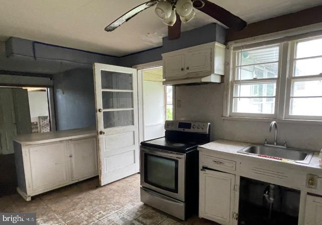 3001 Church Rd, Cherry Hill, NJ 08002 - kitchen featuring electric stove, ceiling fan, white cabinetry, light tile patterned floors, and under cabinet range hood