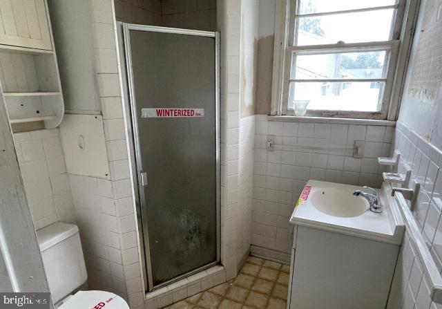 3001 Church Rd, Cherry Hill, NJ 08002 - full bath with tile walls, vanity, a shower stall, and tile patterned floors