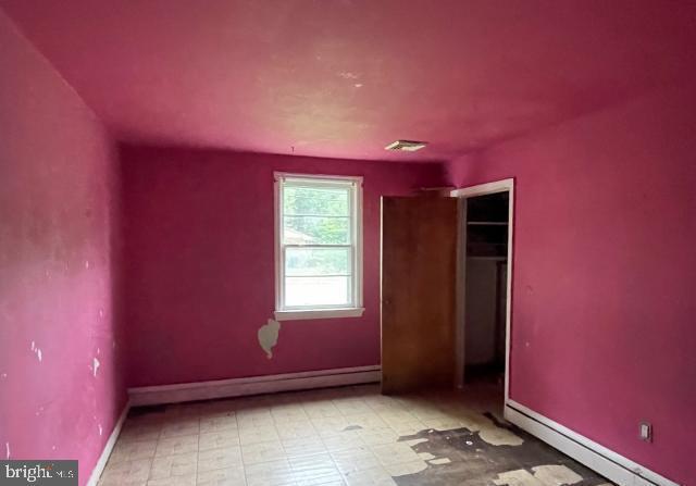 3001 Church Rd, Cherry Hill, NJ 08002 - unfurnished bedroom with a baseboard heating unit and a closet