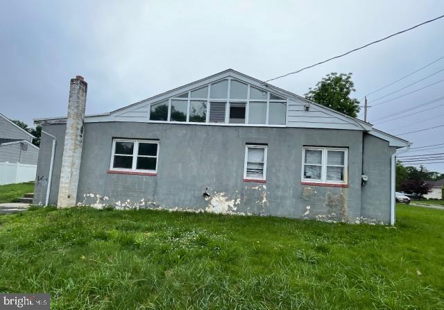 3001 Church Rd, Cherry Hill, NJ 08002 - view of property exterior featuring a yard, stucco siding, and a chimney