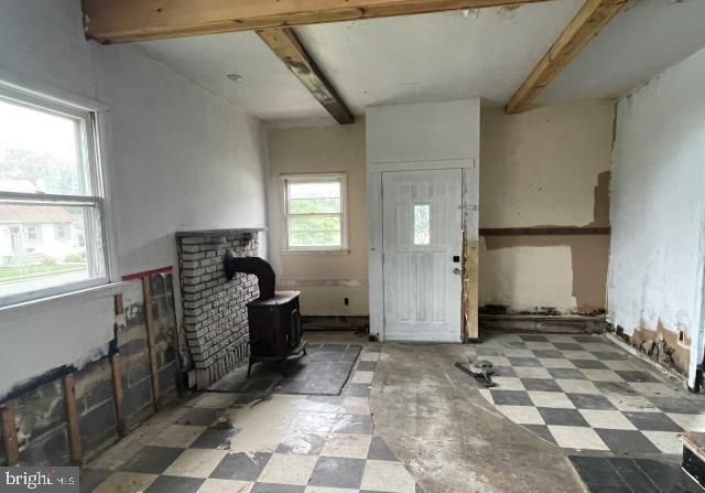 3001 Church Rd, Cherry Hill, NJ 08002 - foyer entrance with a wood stove, tile patterned floors, and beamed ceiling