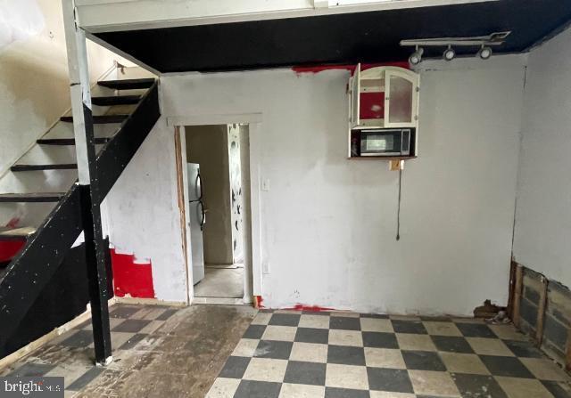 3001 Church Rd, Cherry Hill, NJ 08002 - below grade area featuring stairway and freestanding refrigerator