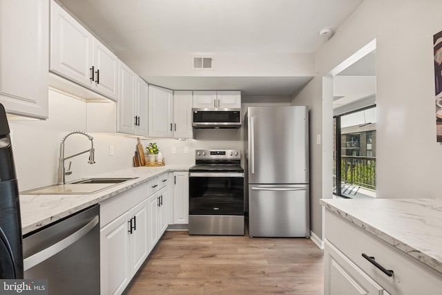9733 Kings Crown Ct Unit 202, Fairfax, VA 22031 - kitchen featuring appliances with stainless steel finishes, white cabinets, and light wood-type flooring