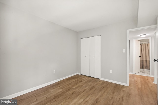 9733 Kings Crown Ct Unit 202, Fairfax, VA 22031 - unfurnished bedroom with light wood finished floors and a closet