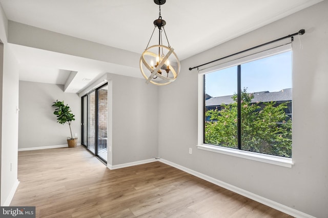 9733 Kings Crown Ct Unit 202, Fairfax, VA 22031 - unfurnished room featuring a chandelier, plenty of natural light, and wood finished floors