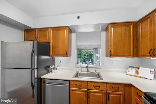 545 E Braddock Rd E Unit 302, Alexandria, VA 22314 - kitchen with stainless steel appliances, brown cabinetry, and light countertops