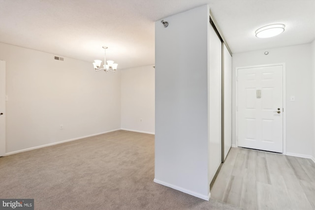 15115 Interlachen Dr Unit 3-415, Silver Spring, MD 20906 - unfurnished room featuring a chandelier and light colored carpet