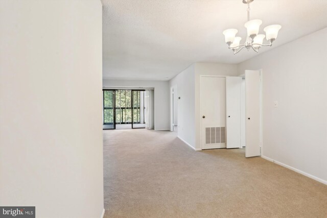 15115 Interlachen Dr Unit 3-415, Silver Spring, MD 20906 - carpeted empty room with a chandelier and baseboards