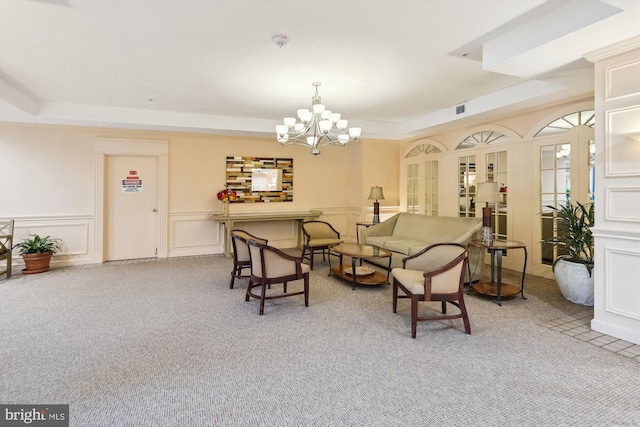 15115 Interlachen Dr Unit 3-415, Silver Spring, MD 20906 - living area featuring a raised ceiling, a chandelier, carpet, a decorative wall, and wainscoting