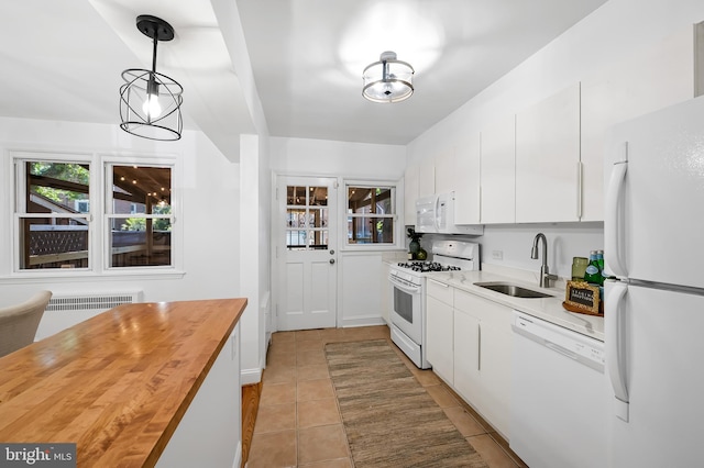 3718 Yolando Rd, Baltimore, MD 21218 - kitchen featuring white appliances, wood counters, radiator, light tile patterned floors, and white cabinets