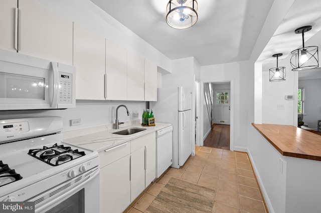 3718 Yolando Rd, Baltimore, MD 21218 - kitchen with white appliances, light tile patterned floors, white cabinets, and healthy amount of natural light
