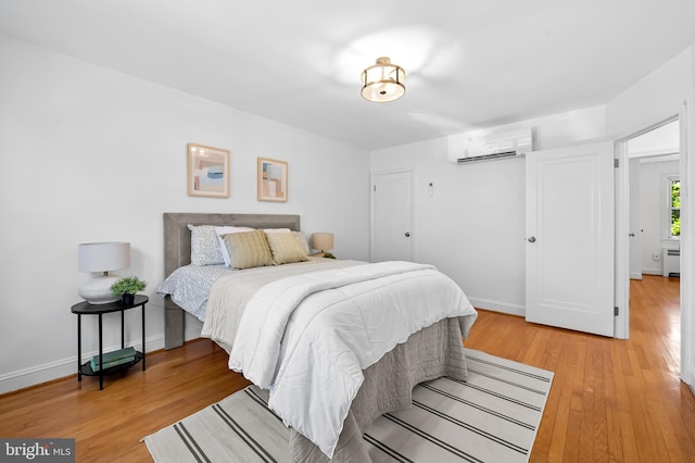 3718 Yolando Rd, Baltimore, MD 21218 - bedroom featuring a wall mounted air conditioner and light wood finished floors