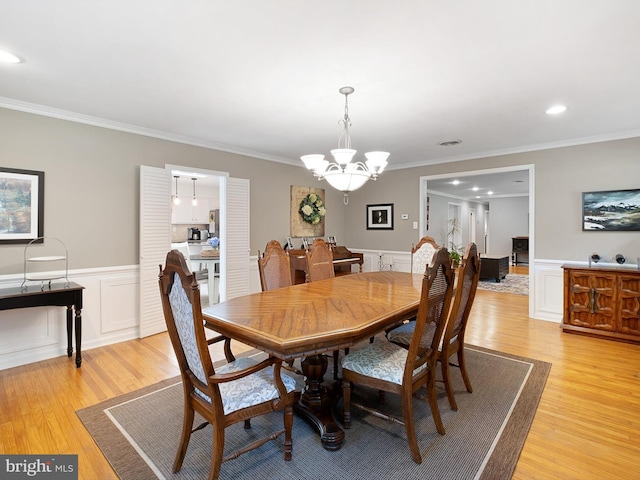 451 E Lafayette Dr, West Chester, PA 19382 - dining room featuring a wainscoted wall, a chandelier, ornamental molding, a decorative wall, and light wood finished floors