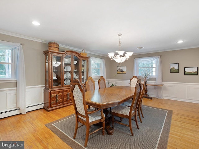 451 E Lafayette Dr, West Chester, PA 19382 - dining room with a chandelier, crown molding, a wainscoted wall, light wood-style flooring, and a decorative wall