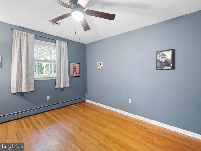 451 E Lafayette Dr, West Chester, PA 19382 - empty room featuring baseboard heating, wood finished floors, and a ceiling fan