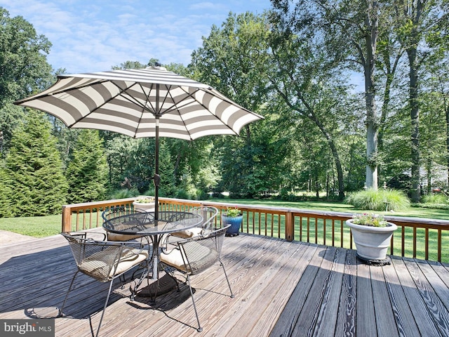 451 E Lafayette Dr, West Chester, PA 19382 - wooden deck with outdoor dining area, a yard, and view of wooded area