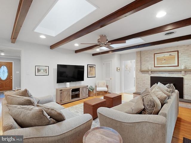 451 E Lafayette Dr, West Chester, PA 19382 - living room featuring light wood-style flooring, beamed ceiling, a ceiling fan, a fireplace, and recessed lighting