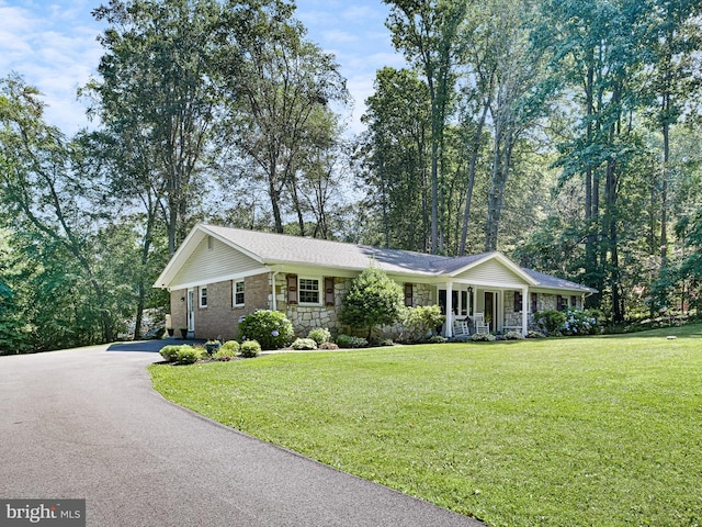 451 E Lafayette Dr, West Chester, PA 19382 - ranch-style home with covered porch, asphalt driveway, a front yard, and stone siding