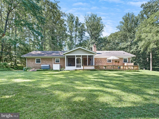 451 E Lafayette Dr, West Chester, PA 19382 - back of house with a sunroom, a chimney, a yard, brick siding, and a wooden deck