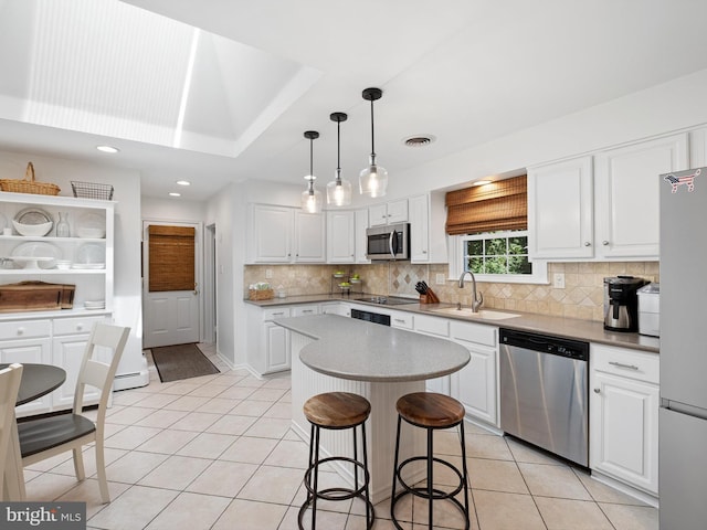 451 E Lafayette Dr, West Chester, PA 19382 - kitchen with stainless steel appliances, light tile patterned floors, white cabinets, a kitchen breakfast bar, and recessed lighting