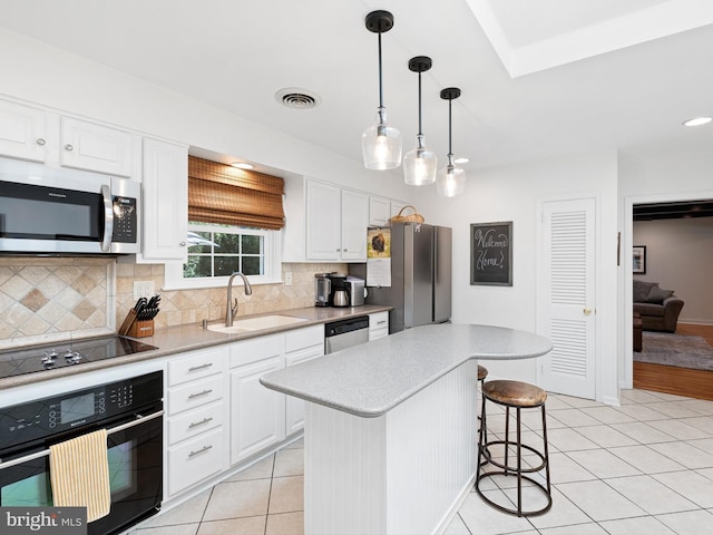 451 E Lafayette Dr, West Chester, PA 19382 - kitchen with black appliances, tasteful backsplash, light tile patterned floors, light countertops, and recessed lighting