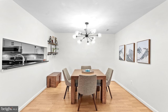 6900 Mary Caroline Cir Unit L, Alexandria, VA 22310 - dining room featuring a chandelier and light wood-type flooring