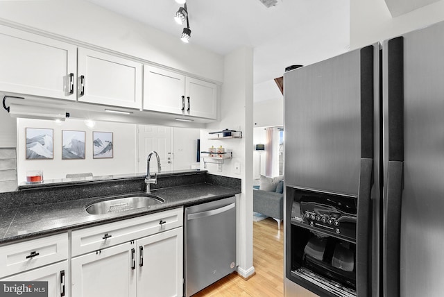 6900 Mary Caroline Cir Unit L, Alexandria, VA 22310 - kitchen with appliances with stainless steel finishes, white cabinets, light wood-style flooring, and dark stone counters