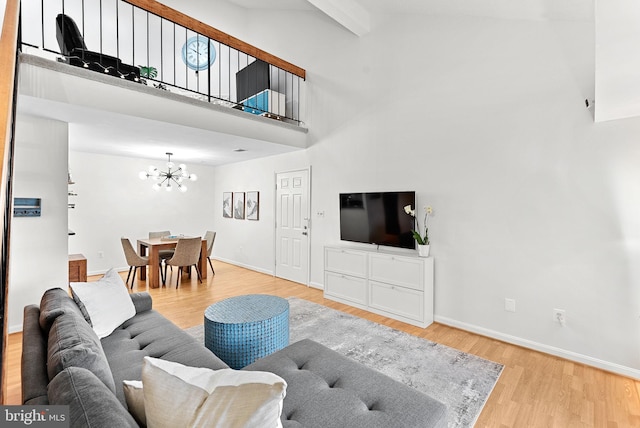 6900 Mary Caroline Cir Unit L, Alexandria, VA 22310 - living area featuring a towering ceiling, a chandelier, and wood finished floors