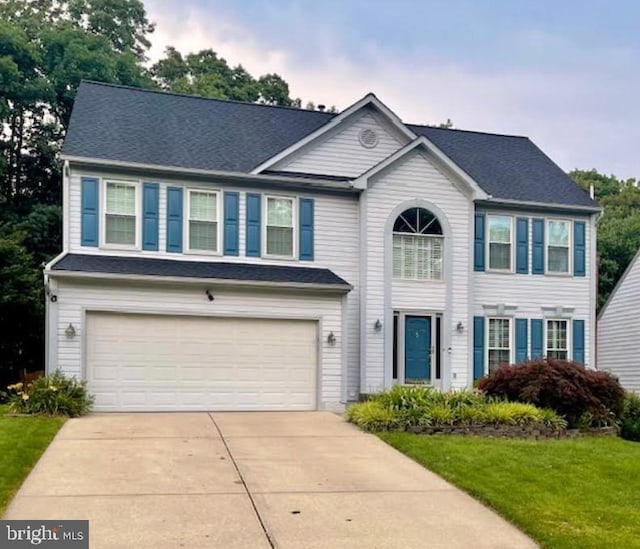 9112 Silver Pointe Way, Fairfax Station, VA 22039 - view of front of house with an attached garage, concrete driveway, a shingled roof, and a front lawn