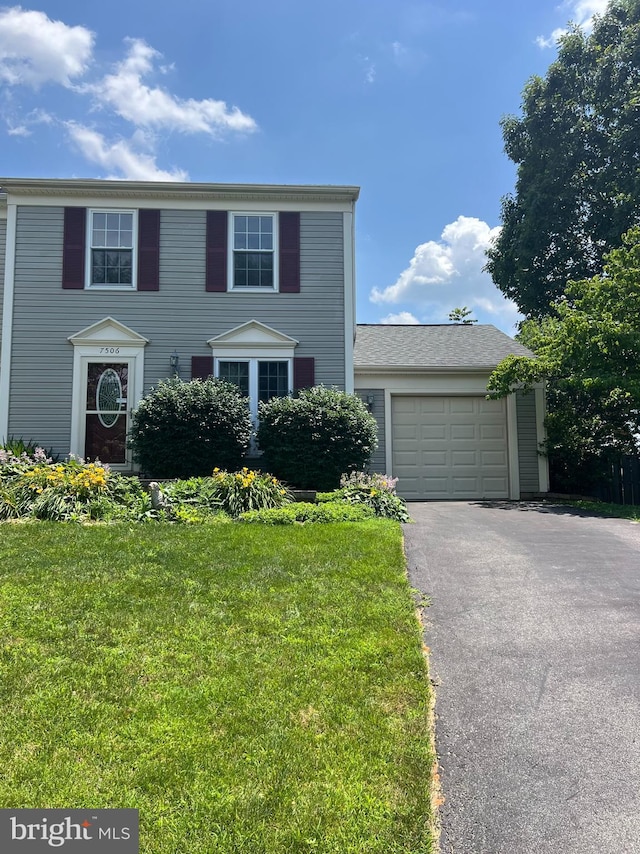 7506 Filbert Ter, Gaithersburg, MD 20879 - view of front of property with asphalt driveway, a front yard, and a garage