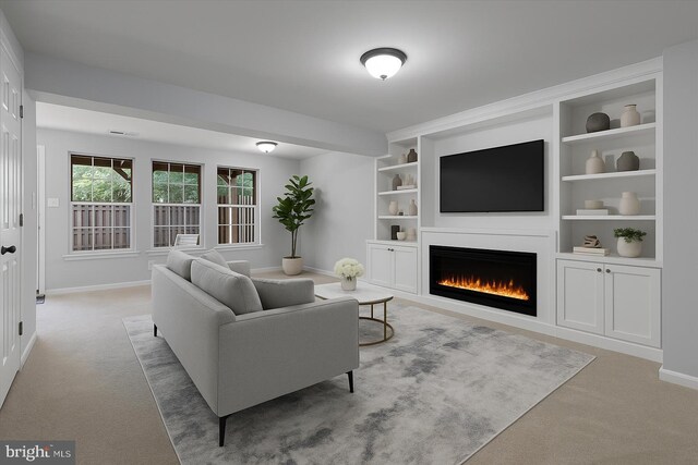 12749 Stone Lined Cir, Woodbridge, VA 22192 - carpeted living room featuring a lit fireplace and built in features