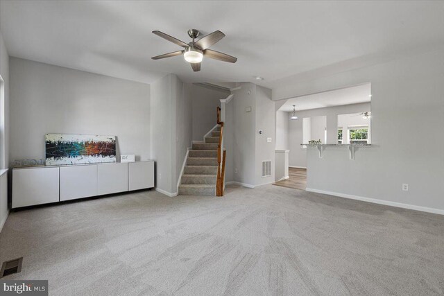 12749 Stone Lined Cir, Woodbridge, VA 22192 - unfurnished living room with a ceiling fan, stairs, and carpet flooring