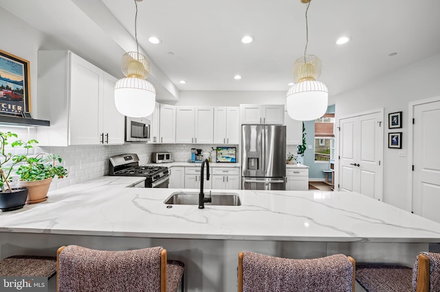 1309 Old Coldspring Ln W, Baltimore, MD 21211 - kitchen featuring stainless steel appliances, tasteful backsplash, light stone countertops, recessed lighting, and a peninsula