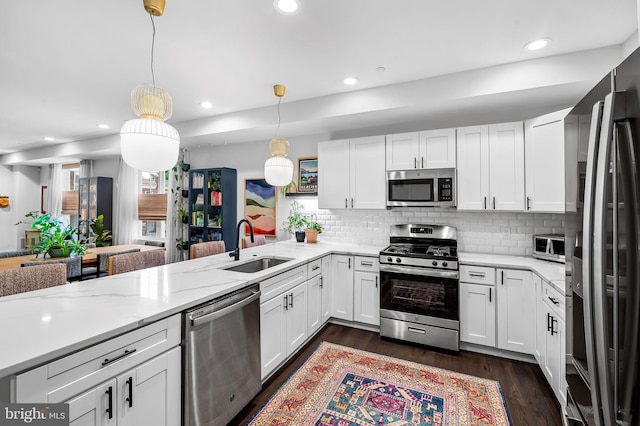 1309 Old Coldspring Ln W, Baltimore, MD 21211 - kitchen featuring stainless steel appliances, white cabinetry, backsplash, dark wood-style flooring, and recessed lighting