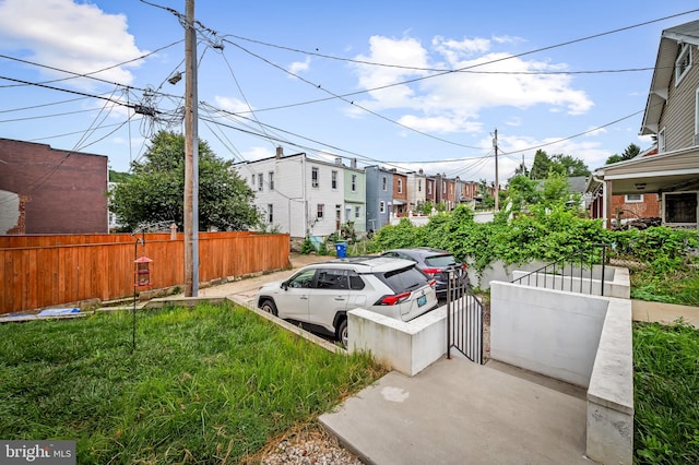1309 Old Coldspring Ln W, Baltimore, MD 21211 - view of vehicle parking featuring a fenced front yard, a gate, and a residential view