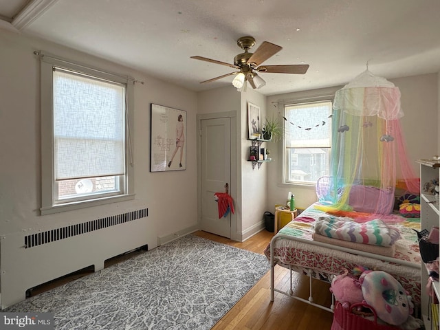 5512 Sefton Ave, Baltimore, MD 21214 - bedroom featuring radiator, wood finished floors, and ceiling fan