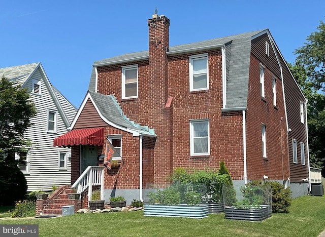 5512 Sefton Ave, Baltimore, MD 21214 - rear view of property with a yard, a chimney, brick siding, and roof with shingles