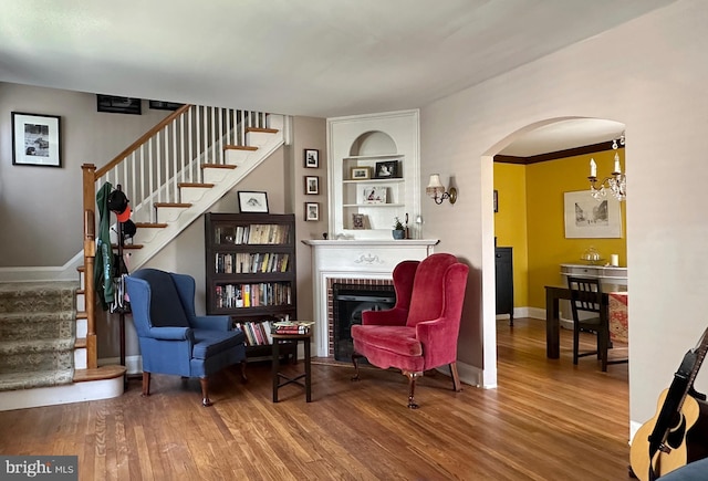 5512 Sefton Ave, Baltimore, MD 21214 - living area with wood finished floors, stairway, arched walkways, and a fireplace