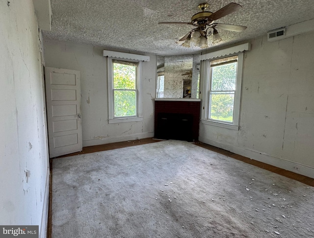 2805 Oakley Ave, Baltimore, MD 21215 - empty room featuring a ceiling fan, a textured ceiling, and a fireplace