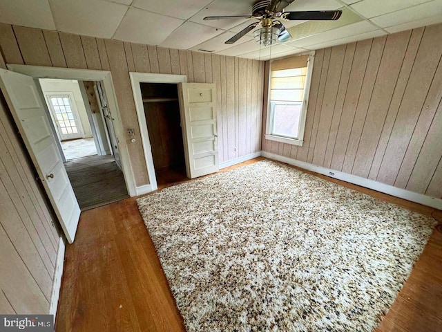 2805 Oakley Ave, Baltimore, MD 21215 - unfurnished bedroom with wood walls, wood finished floors, a closet, and a drop ceiling