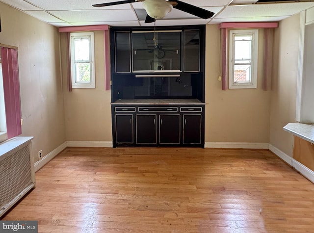 2805 Oakley Ave, Baltimore, MD 21215 - bar area with radiator heating unit, ceiling fan, light wood finished floors, and a drop ceiling