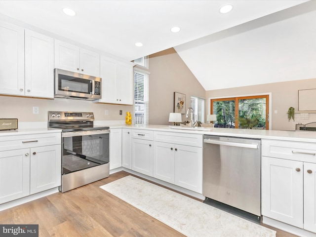 12004 Cheyenne Rd, Gaithersburg, MD 20878 - kitchen with appliances with stainless steel finishes, plenty of natural light, light countertops, recessed lighting, and lofted ceiling