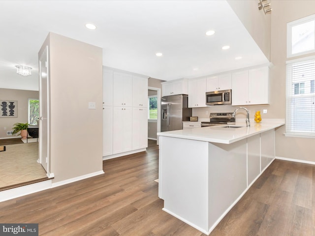12004 Cheyenne Rd, Gaithersburg, MD 20878 - kitchen with appliances with stainless steel finishes, a peninsula, light countertops, white cabinets, and recessed lighting