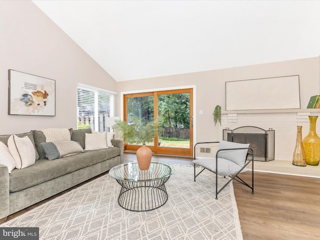 12004 Cheyenne Rd, Gaithersburg, MD 20878 - living area featuring wood finished floors, high vaulted ceiling, and a fireplace