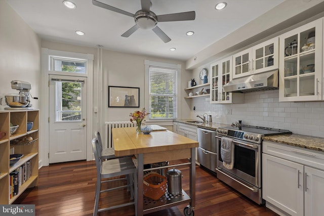 3301 Beech Ave, Baltimore, MD 21211 - kitchen featuring appliances with stainless steel finishes, under cabinet range hood, light stone counters, white cabinets, and tasteful backsplash