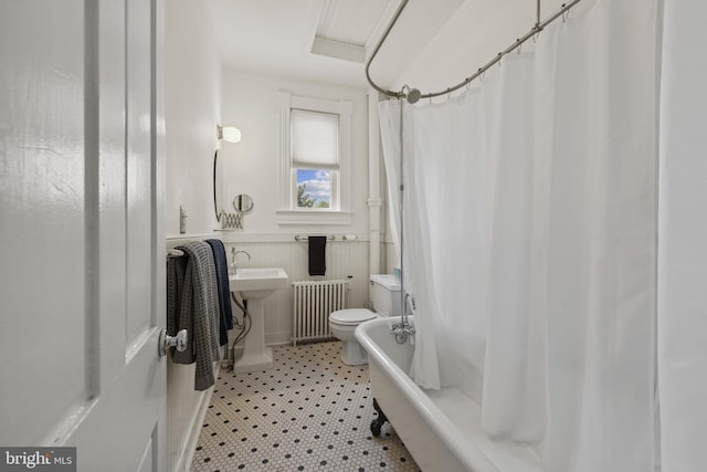 3301 Beech Ave, Baltimore, MD 21211 - full bathroom with radiator heating unit, shower / bathtub combination with curtain, tile patterned floors, and wainscoting