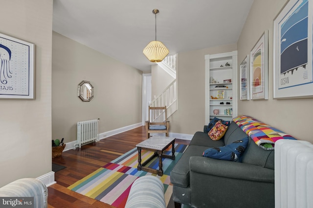 3301 Beech Ave, Baltimore, MD 21211 - living room with radiator heating unit, stairway, and wood finished floors