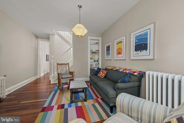 3301 Beech Ave, Baltimore, MD 21211 - living area with radiator, wood finished floors, stairway, and built in features
