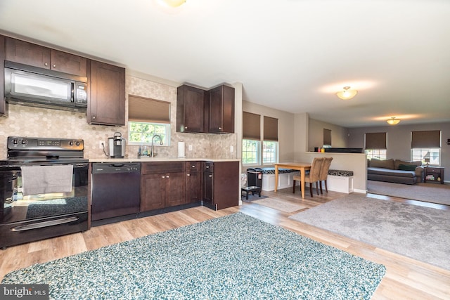 883 N Hanover St, Pottstown, PA 19464 - kitchen with black appliances, dark brown cabinets, light wood-style flooring, and healthy amount of natural light